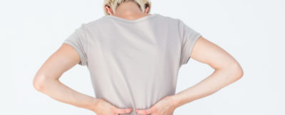 11739960-blonde-woman-having-a-back-ache-and-holding-her-back